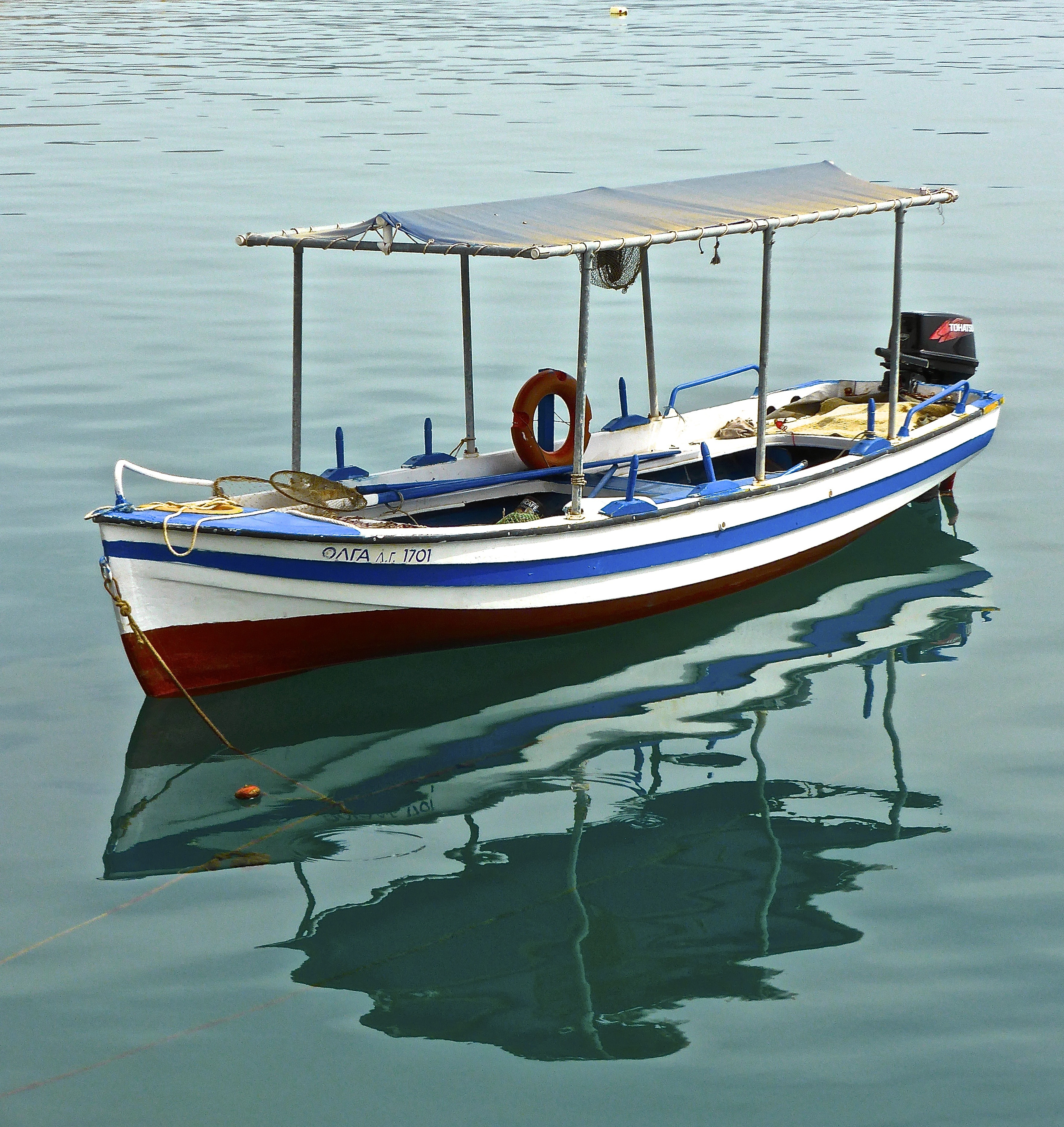 white blue and red boat with outboard motor