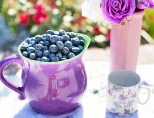 blueberries and purple ceramic pitcher and cup thumbnail