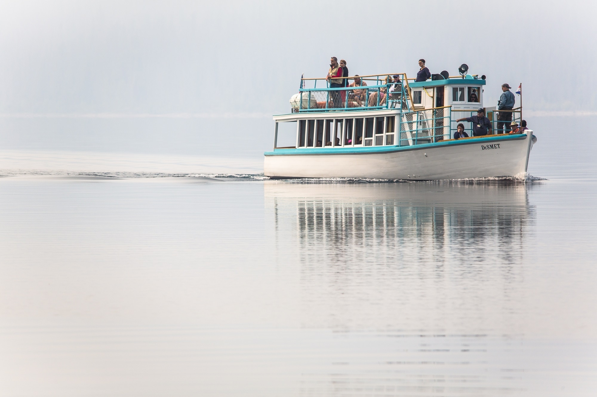people on teal and white boat