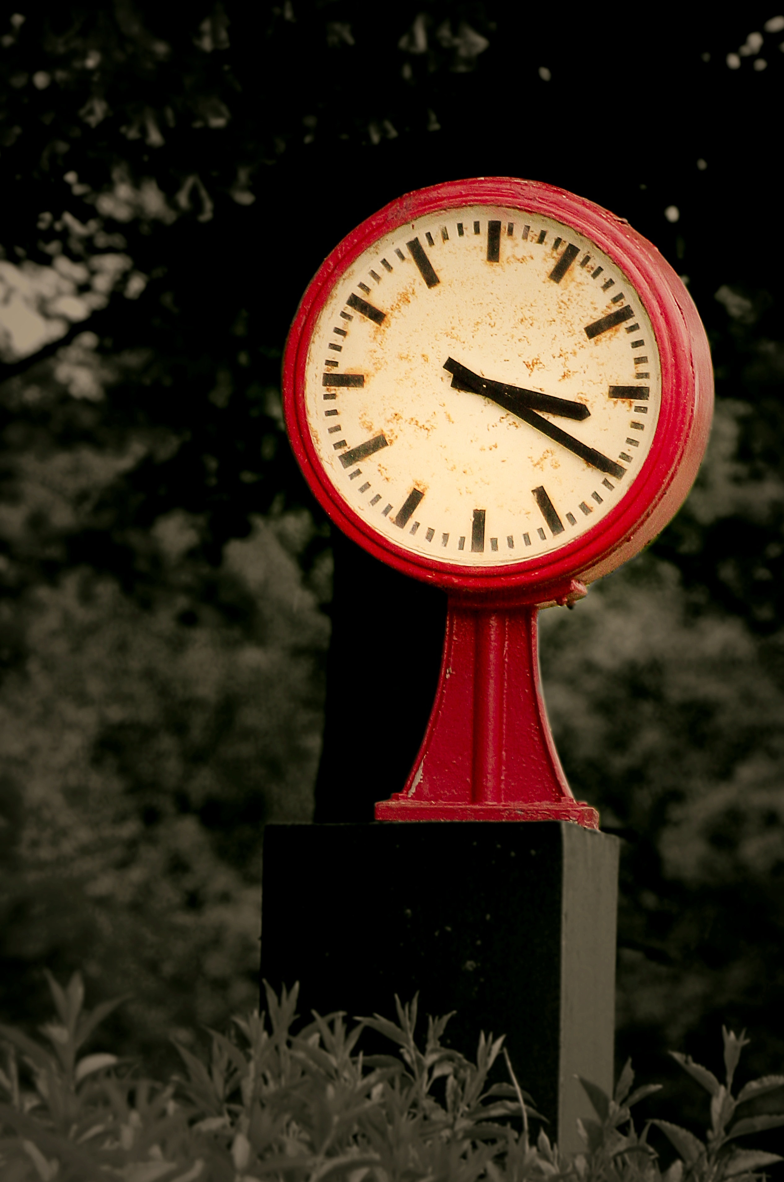 red and white pedestal round analog clock