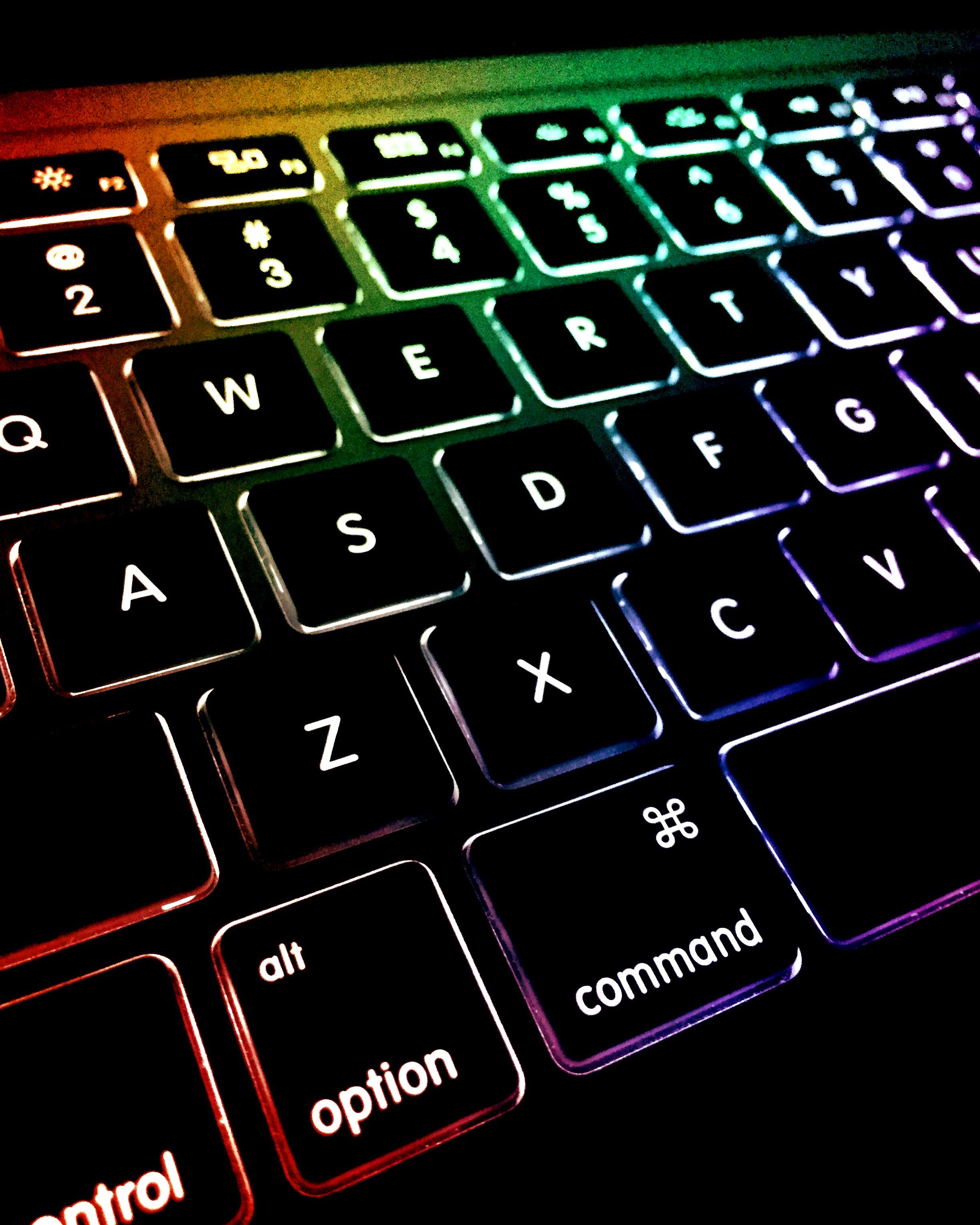 photo of lighted Apple MacBook keyboard