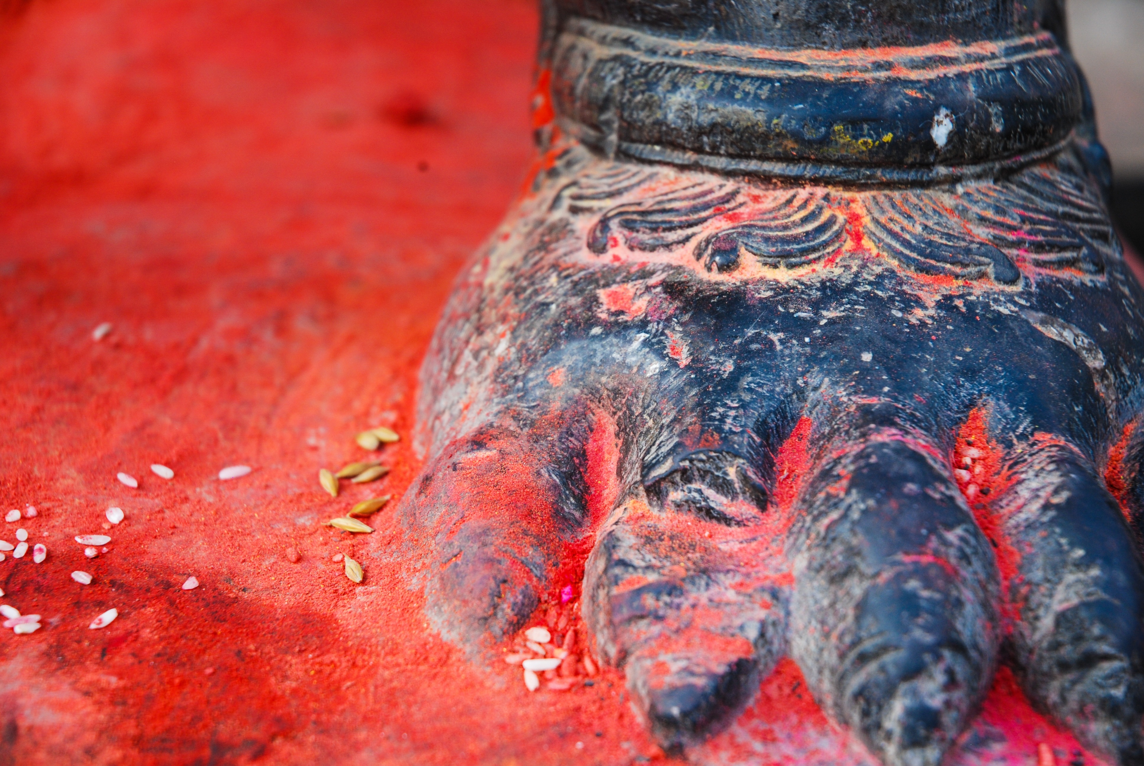 blue ceramic foot on red surface