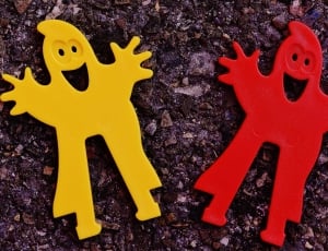 two yellow and red plastic toys thumbnail