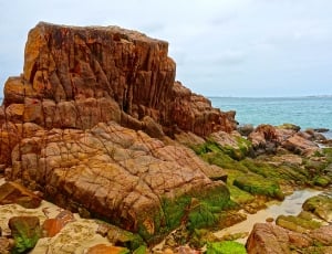 photo of a brown rock on seashore thumbnail