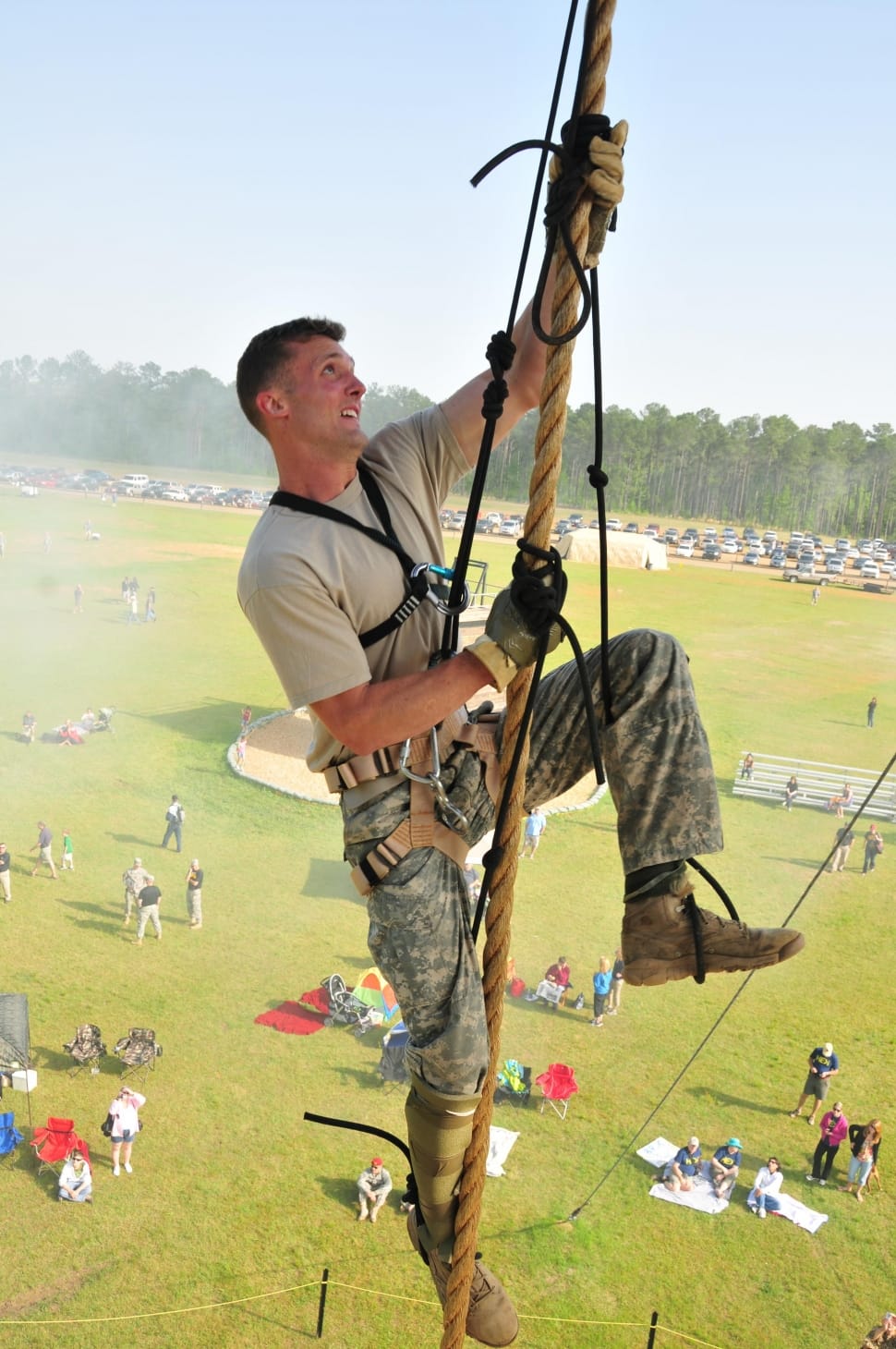 man wearing gray crew neck shirt and camouflage pants on harness during daytime preview
