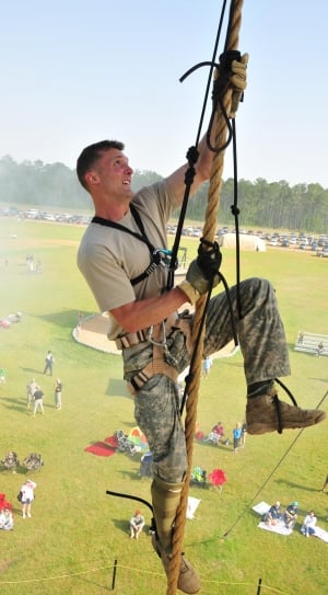 man wearing gray crew neck shirt and camouflage pants on harness during daytime thumbnail