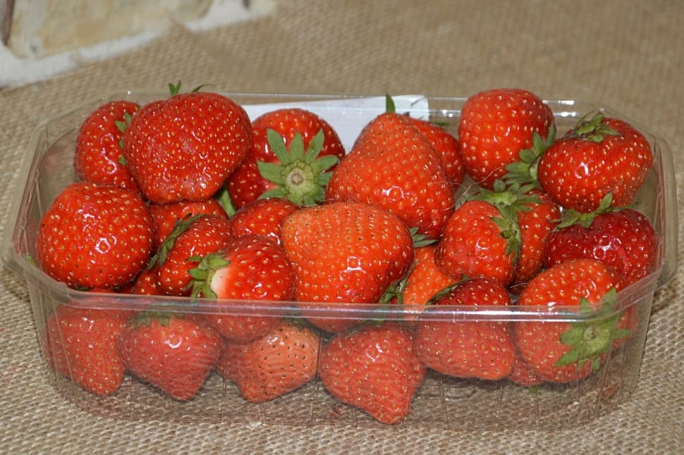 red strawberries in clear glass container preview