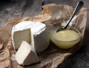 sliced white cheese with cream in clear glass container thumbnail