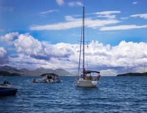 white sail boat on body of water thumbnail