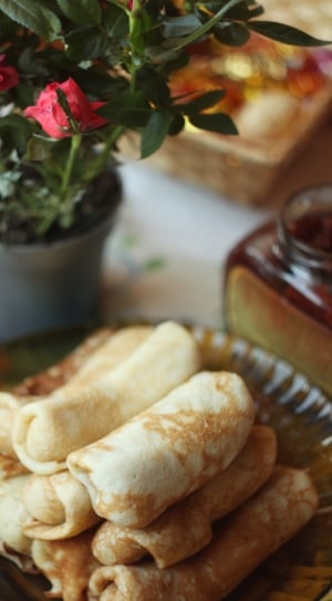 rolled pancakes on glass round plate thumbnail
