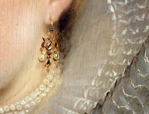 woman wearing gold drop hook earrings thumbnail