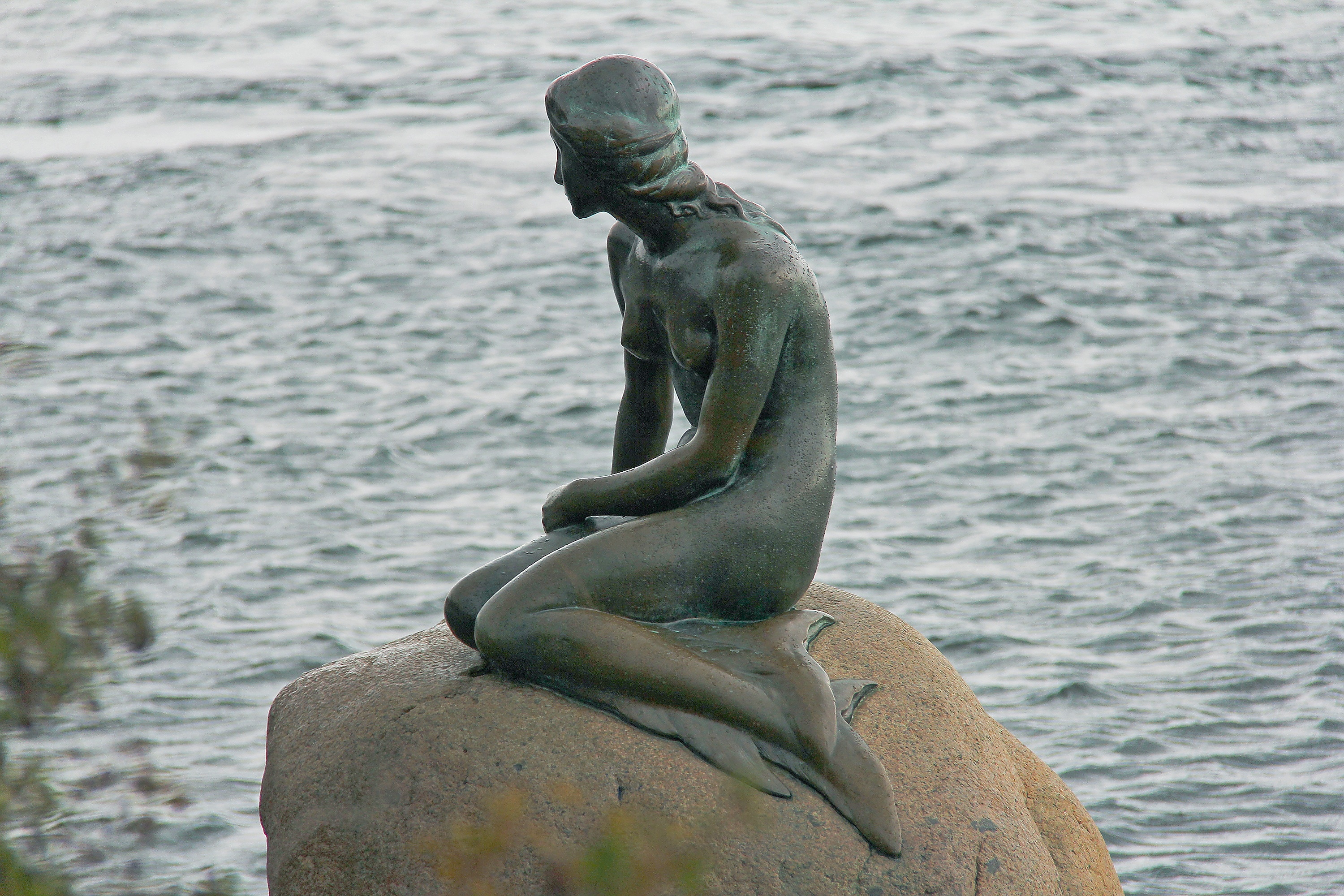 mermaid statue on brown rocks
