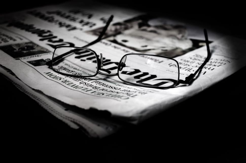 black framed eyeglasses on newspaper preview