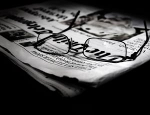 black framed eyeglasses on newspaper thumbnail