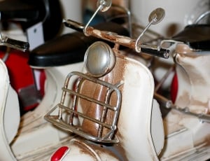 white and beige motor scooter thumbnail