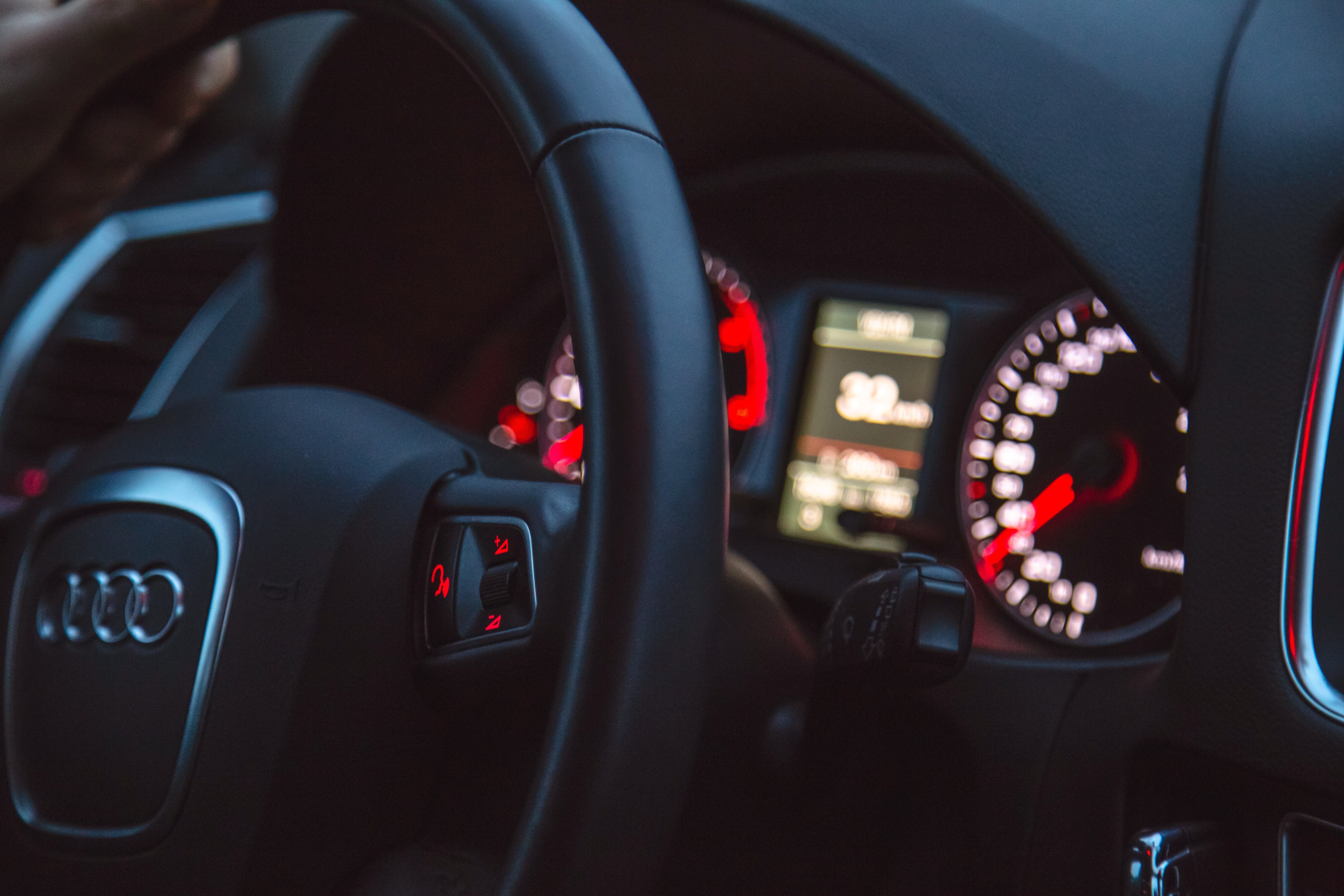 black audio steering wheel with instrumental cluster panel