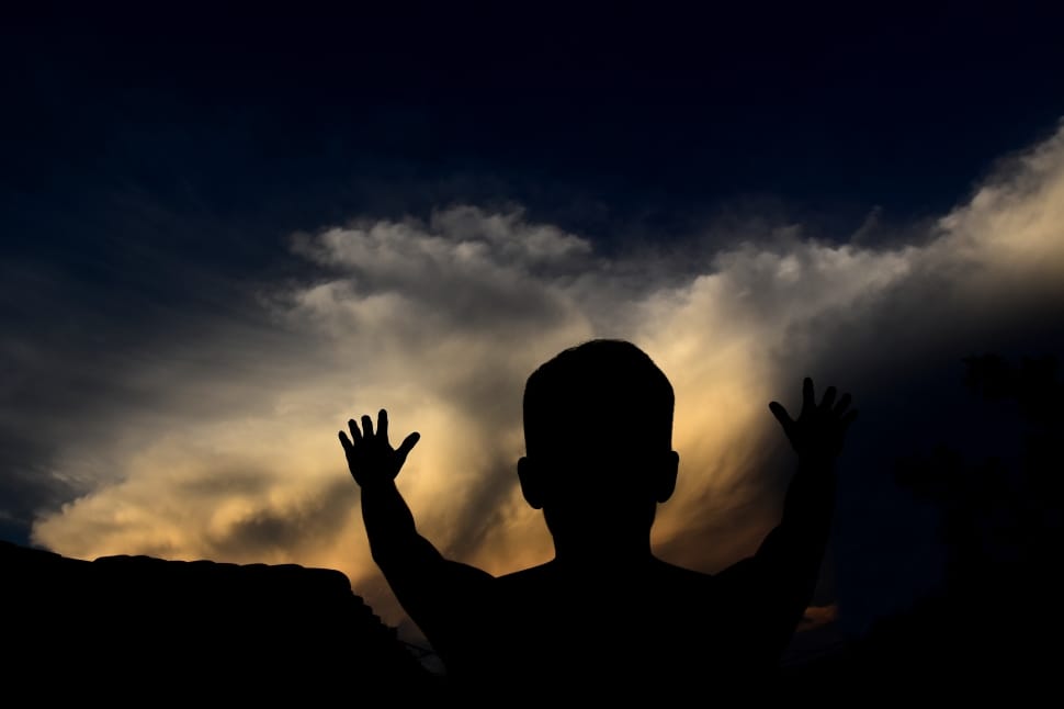 silhouette of person when raising his hands preview