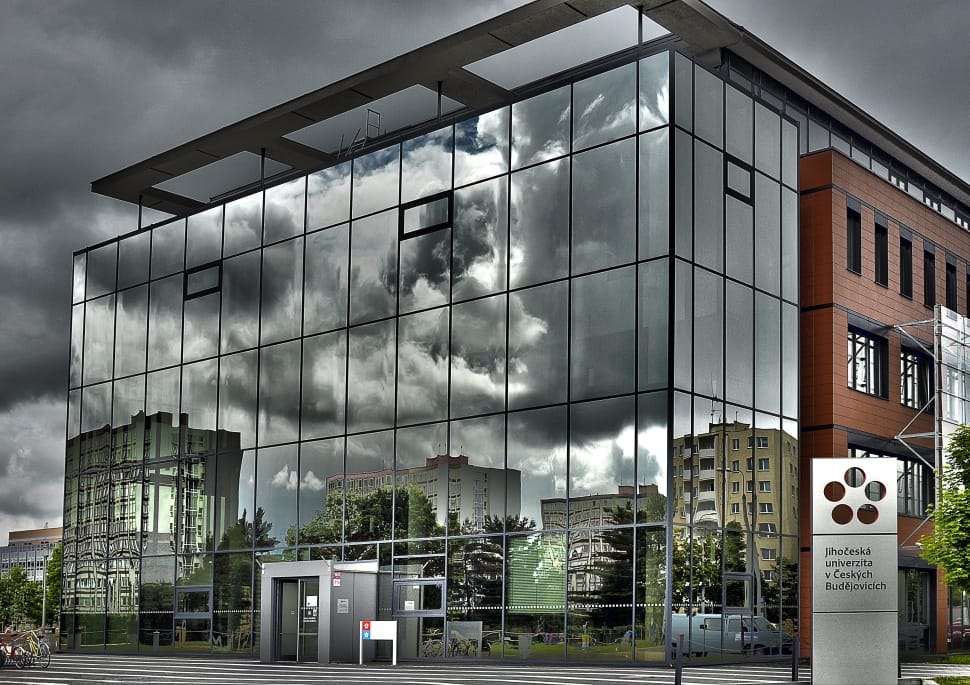 gray glass building under gray clouds preview