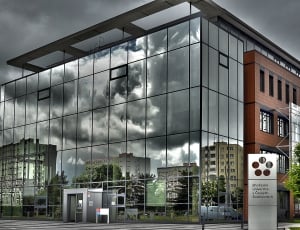 gray glass building under gray clouds thumbnail