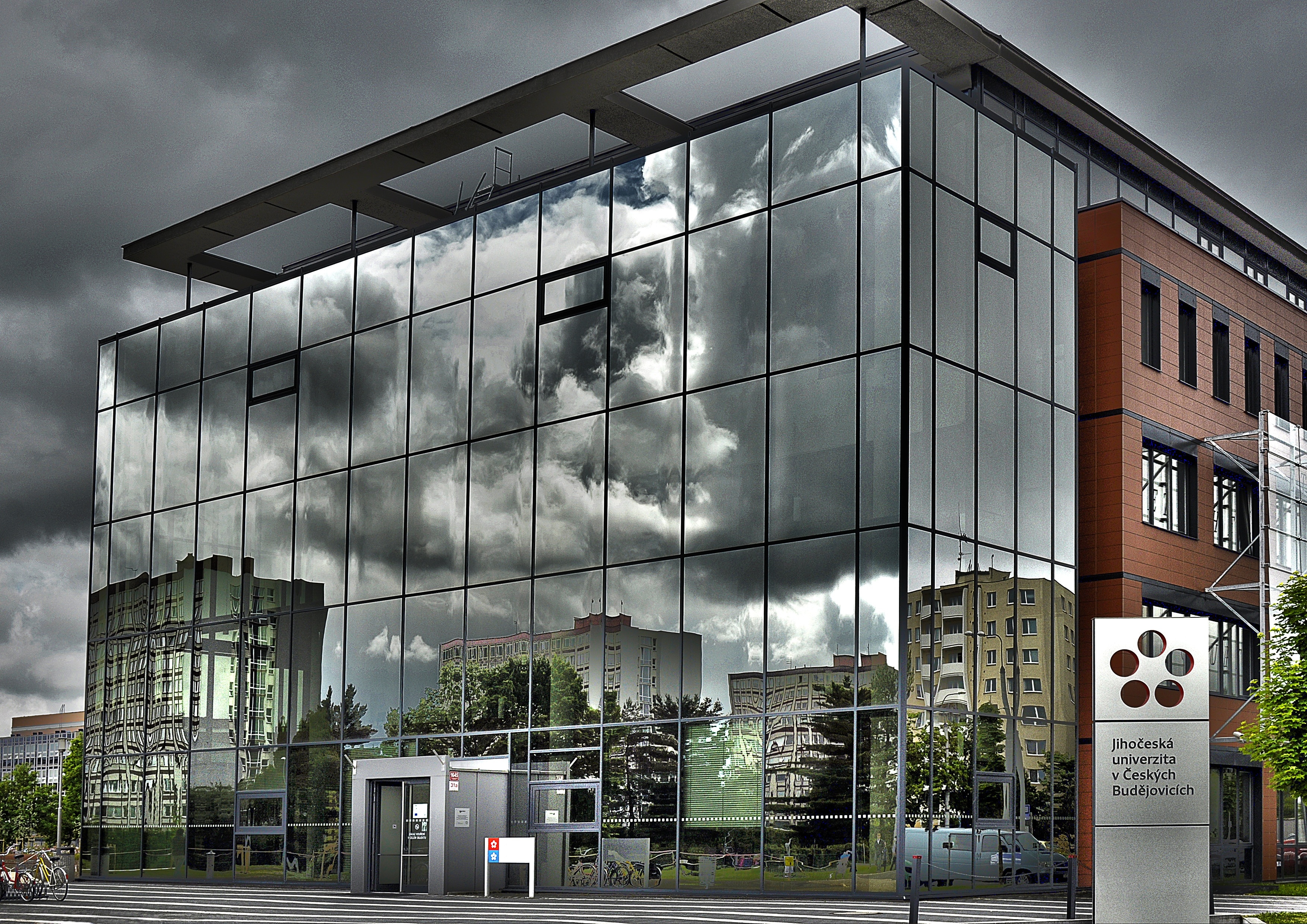 gray glass building under gray clouds