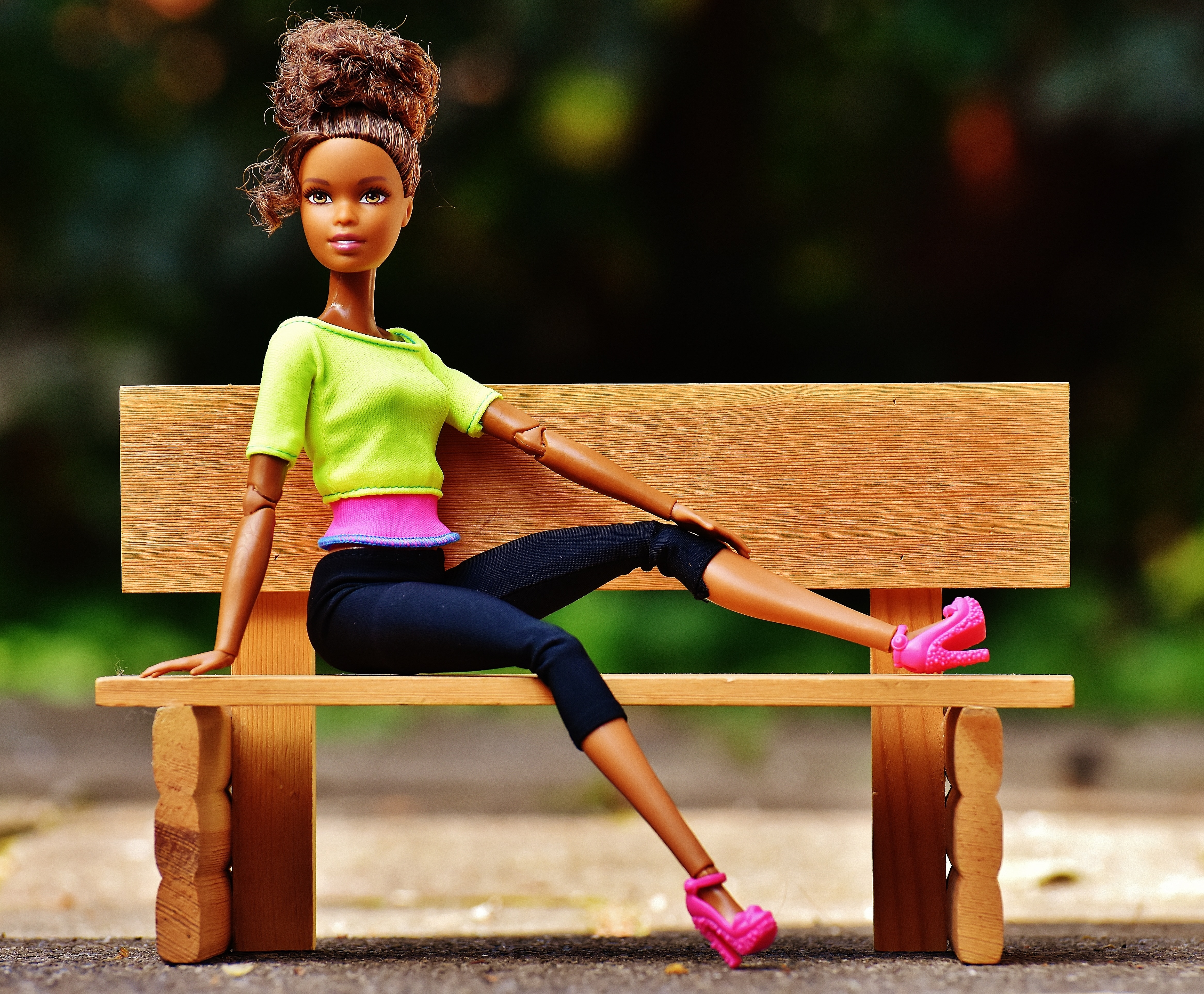brown haired barbie doll with bench