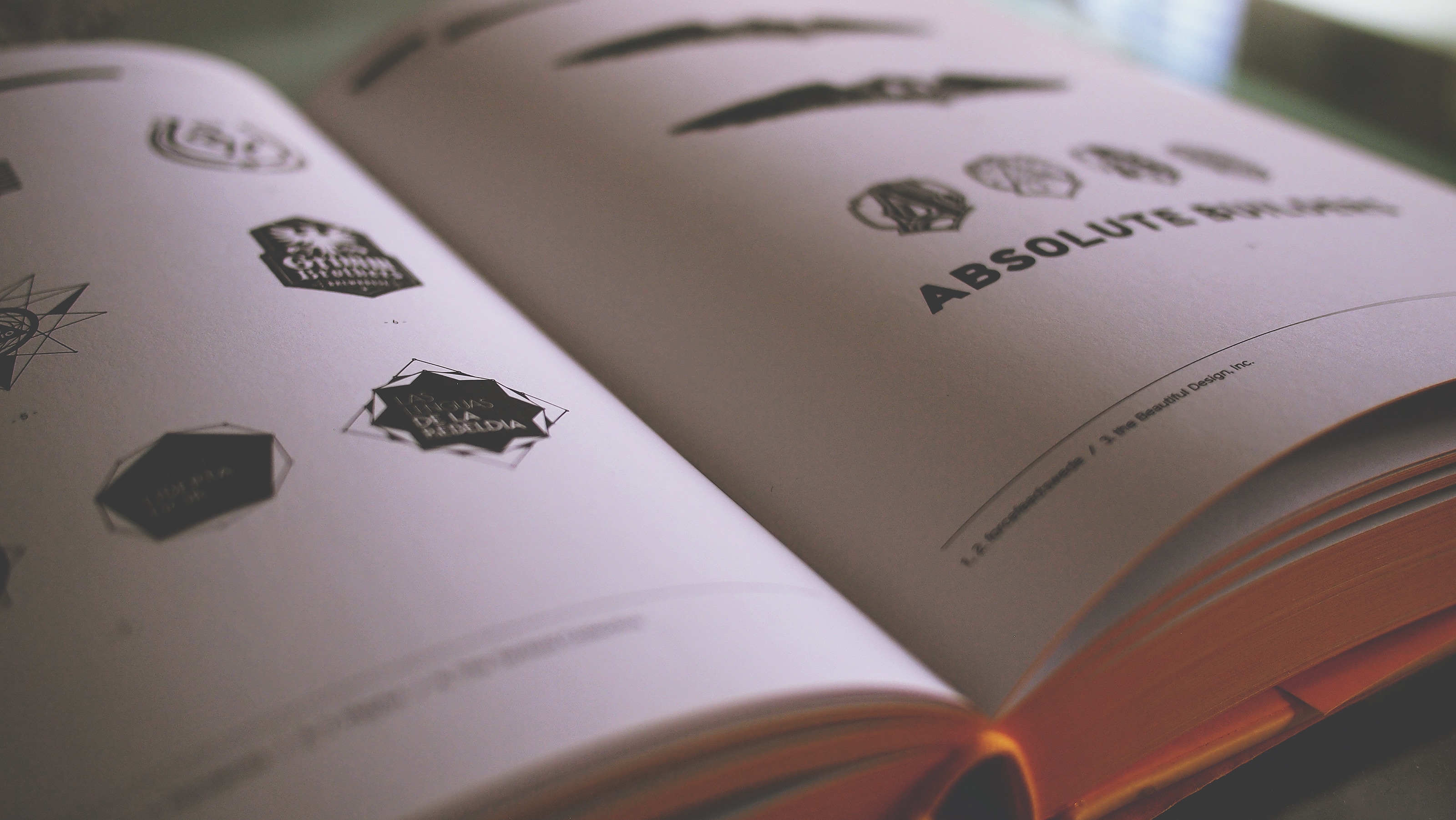white and black logos print book pages