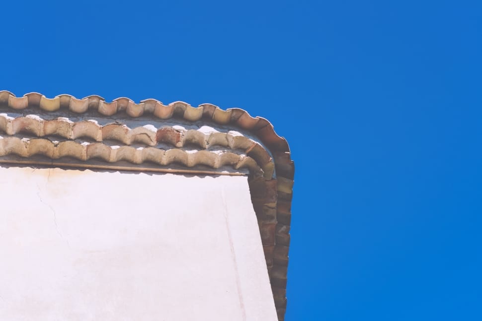low angle photo of roof gutter under calm blue sky preview