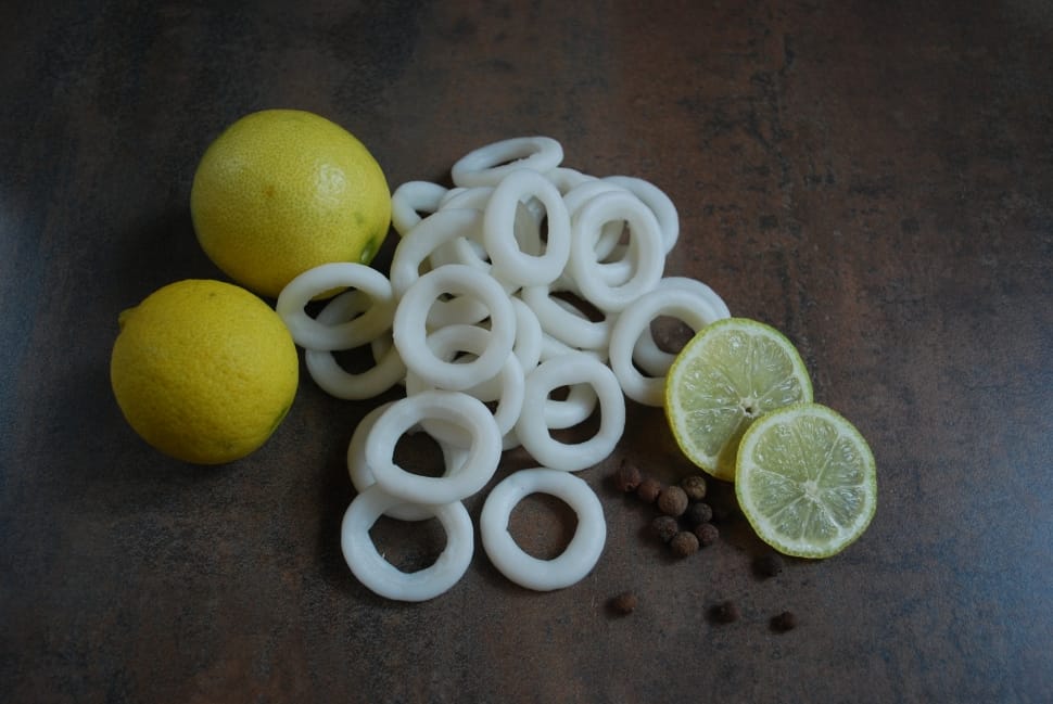 two yellow lemons  beside white sliced fruits preview