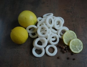 two yellow lemons  beside white sliced fruits thumbnail