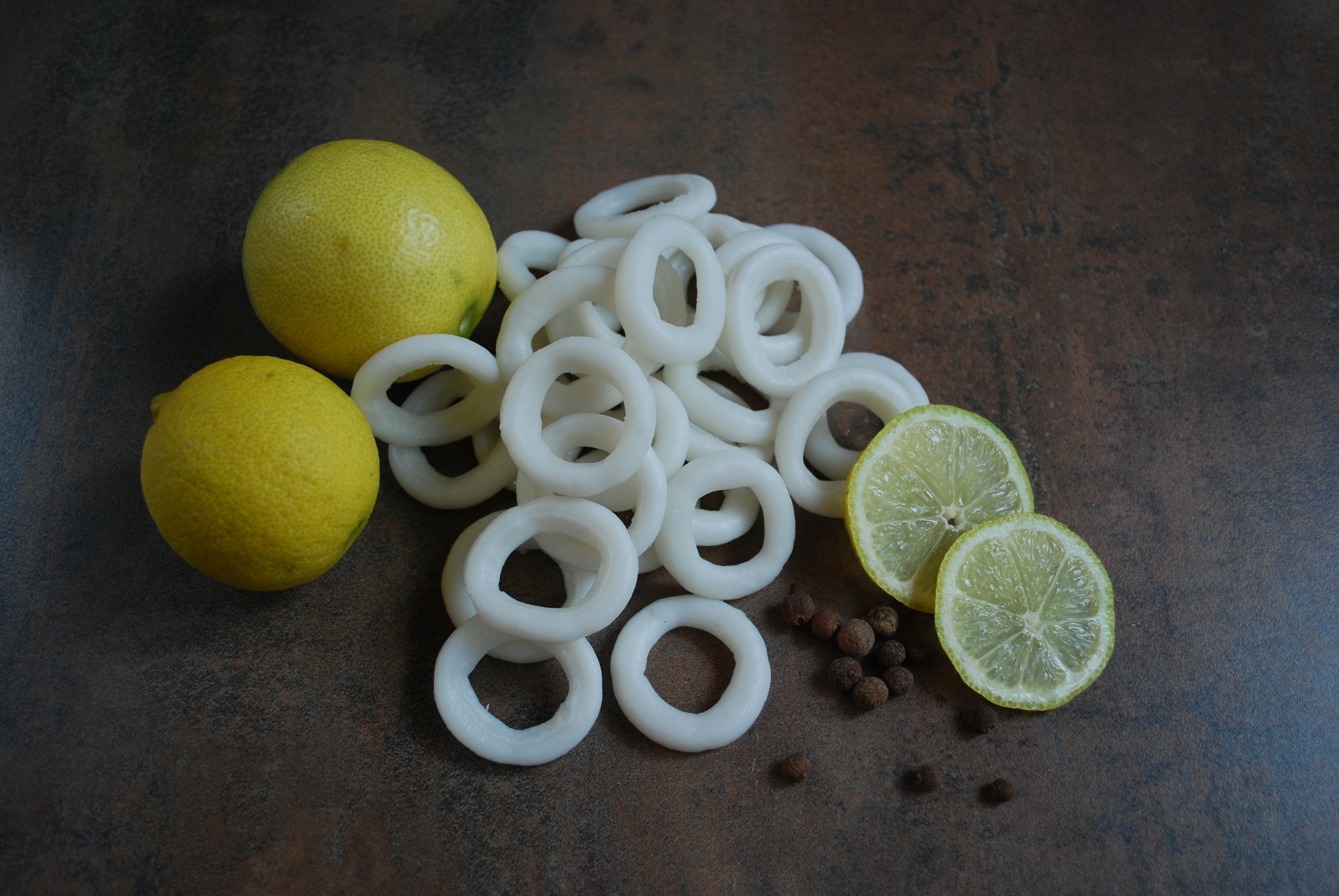 two yellow lemons  beside white sliced fruits