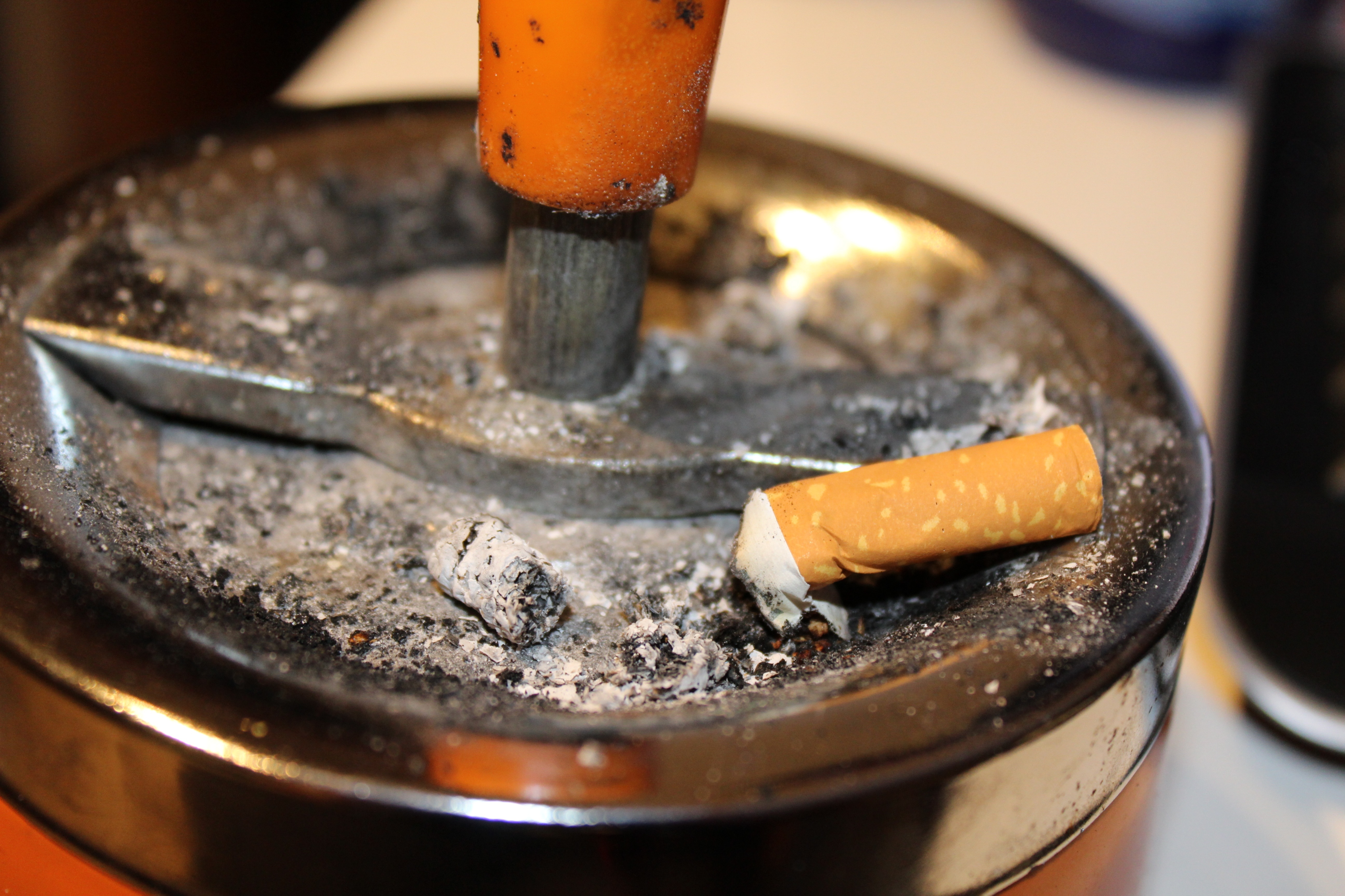 stainless steel ashtray with cigarette butt