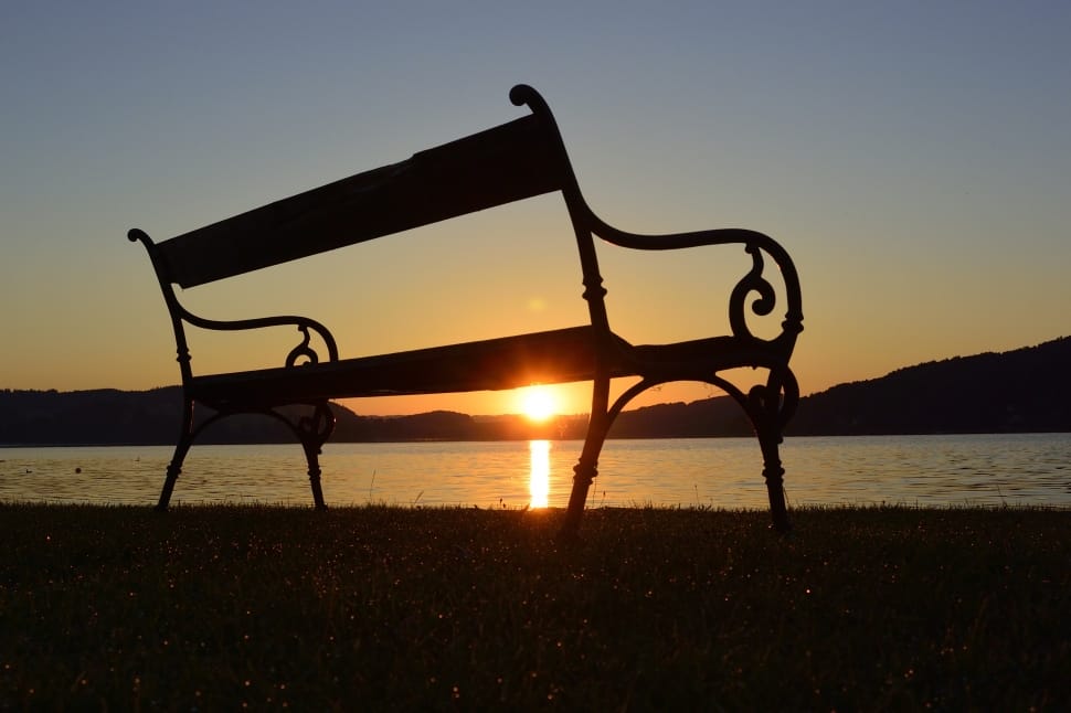 bench near ocean during sunset preview