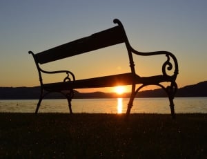 bench near ocean during sunset thumbnail