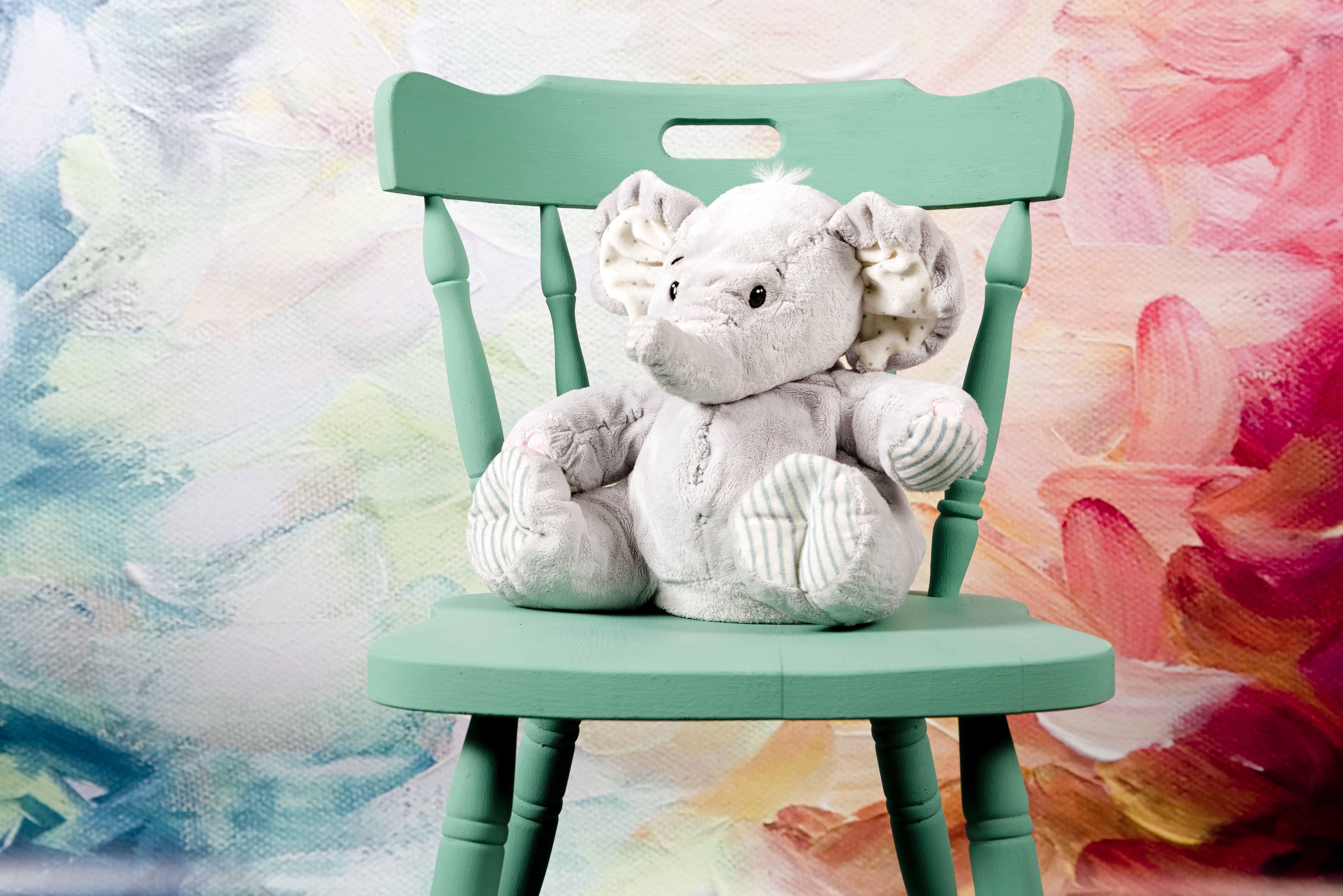 grey elephant plush toy and green windsor chair