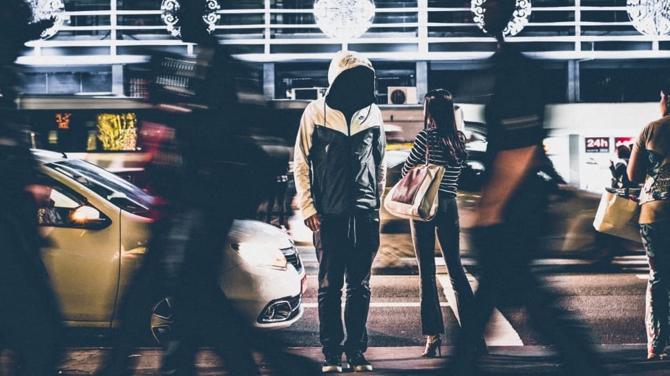 man wearing white and gray hoodie in the middle of the street preview