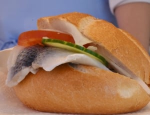 sliced potato cucumber and raw fish filled sandwich thumbnail