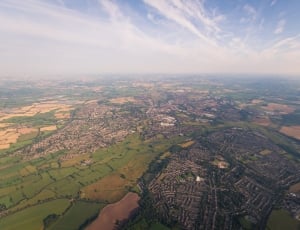 aerial photography of building and green fields thumbnail