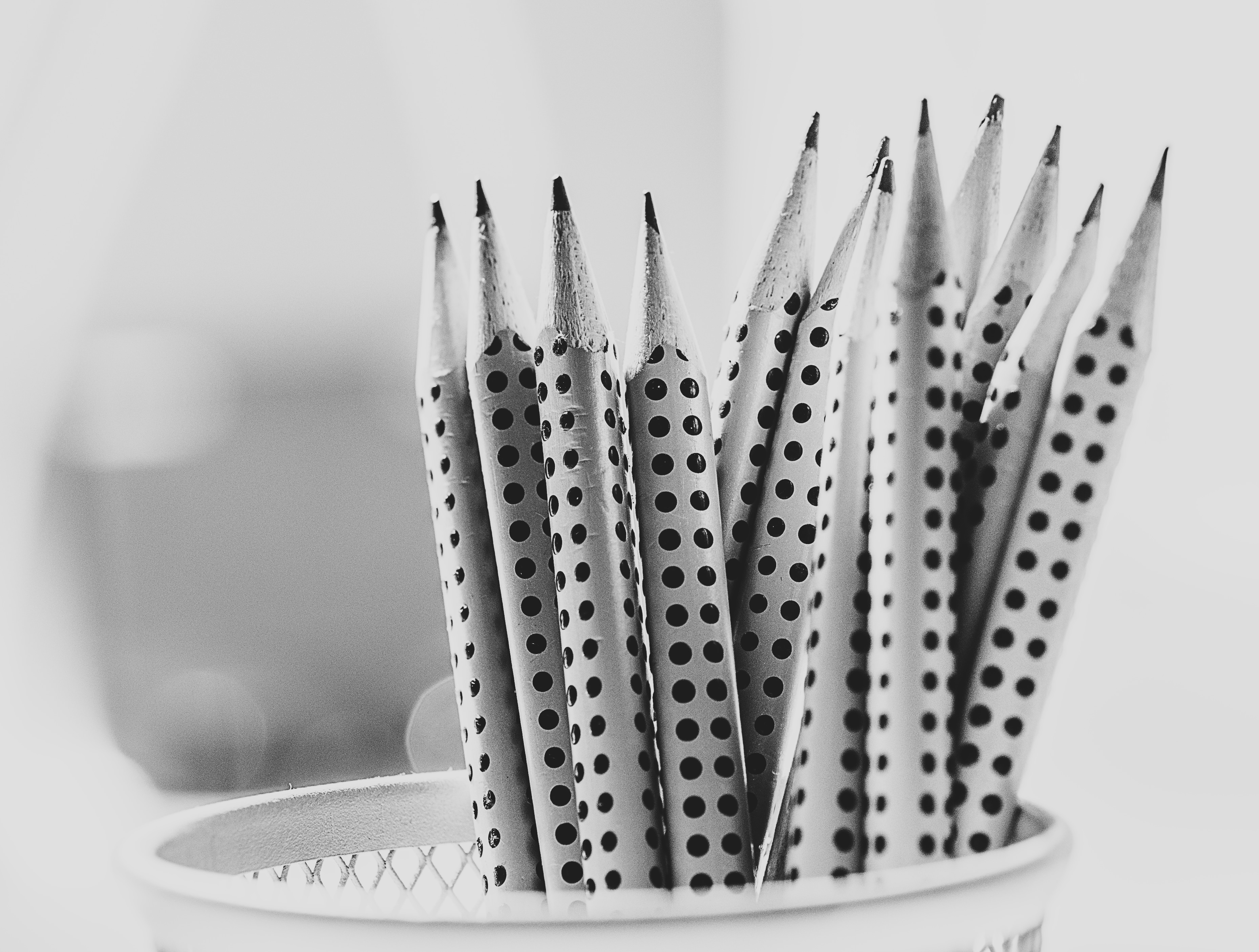 grayscale photo of pencils in pencil holder