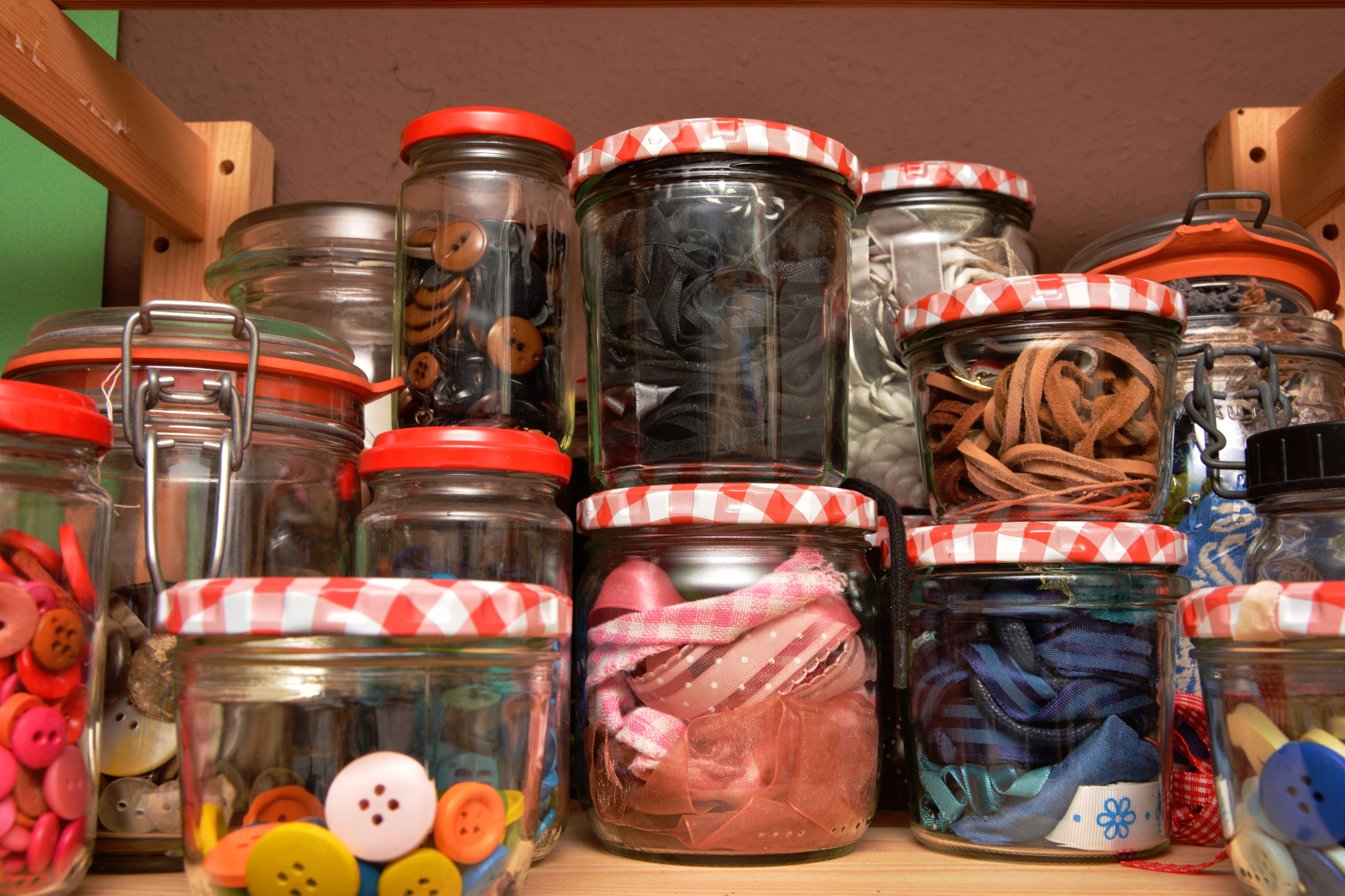 glass jars of clothes buttons and ribbons
