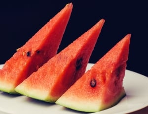three slices of red watermelon on white round ceramic plate thumbnail