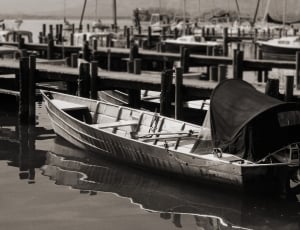 greyscale photo of boat docked at daytime thumbnail