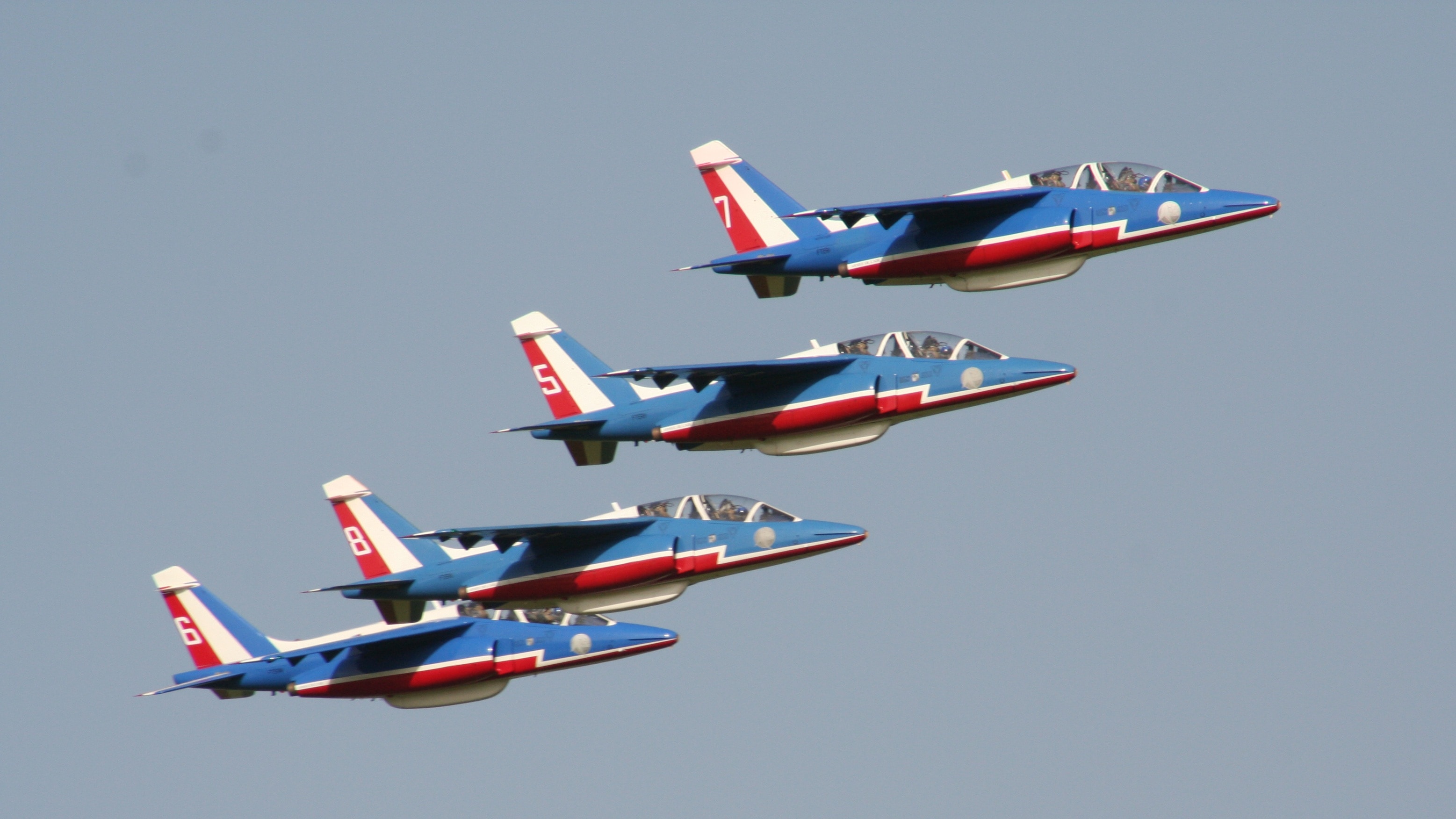 four blue-and-red jets