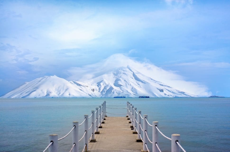 empty pathway on body of water with snow mountain painting preview