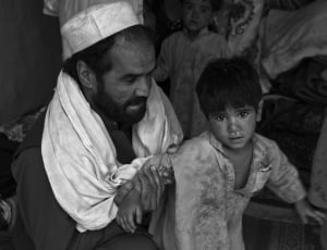 man wearing takiyah holding boy thumbnail