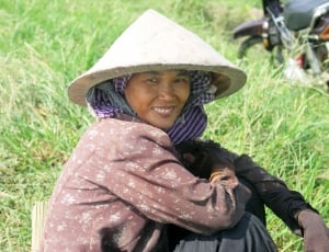 woman in brown long-sleeve top beside green grass thumbnail