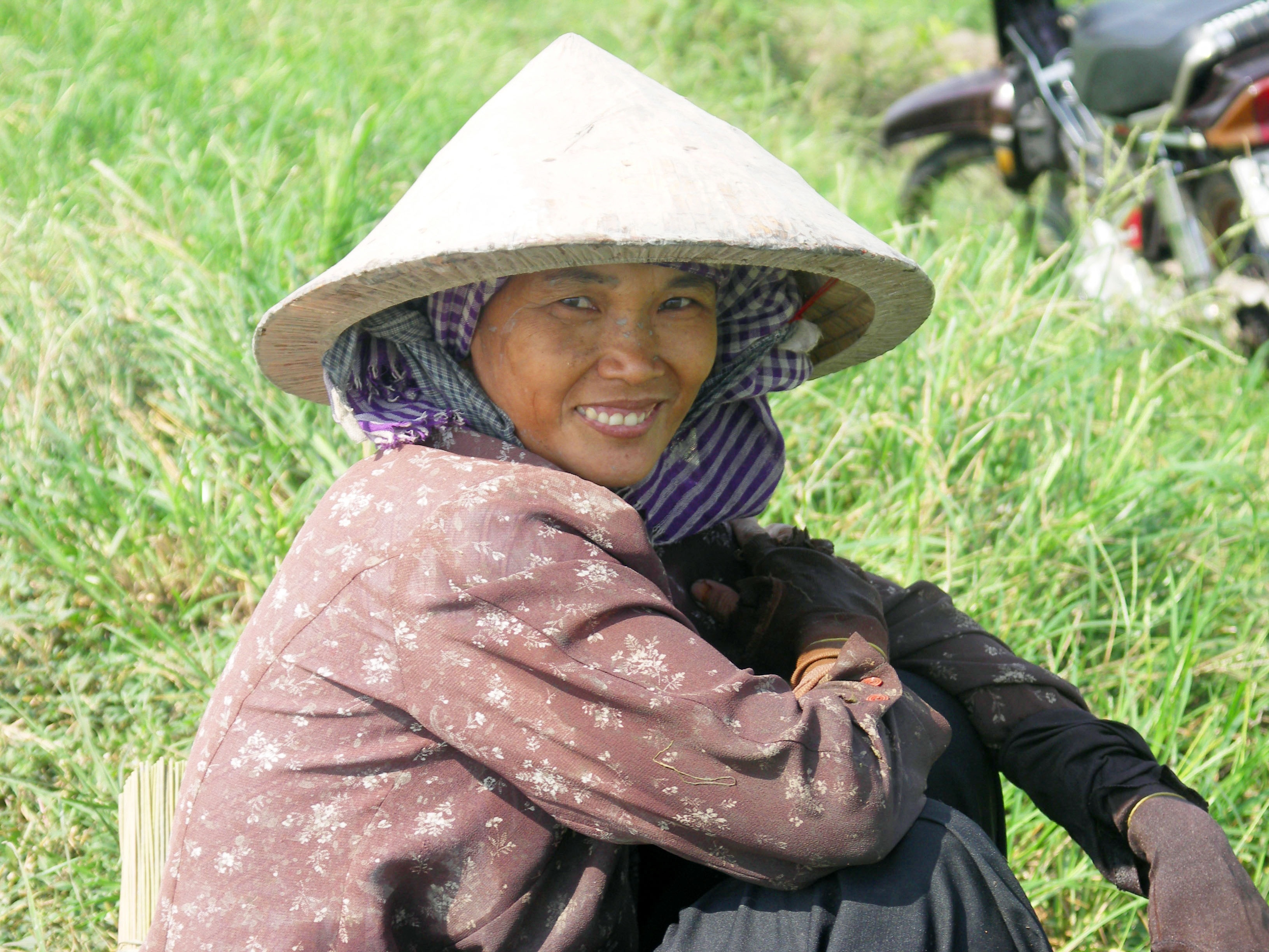 woman in brown long-sleeve top beside green grass