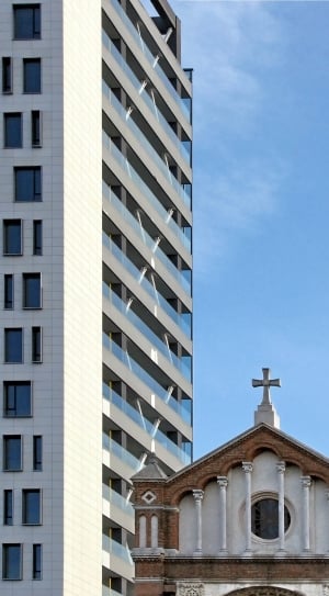 white and brown concrete cathedral and white and brown high rise building thumbnail