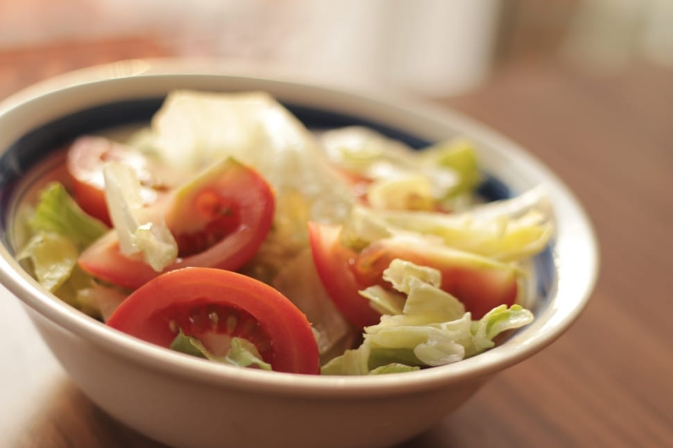 red slice tomatoes and green cabbage on white bowl preview