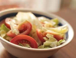 red slice tomatoes and green cabbage on white bowl thumbnail