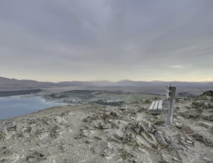 body of water near city under gray clouds thumbnail